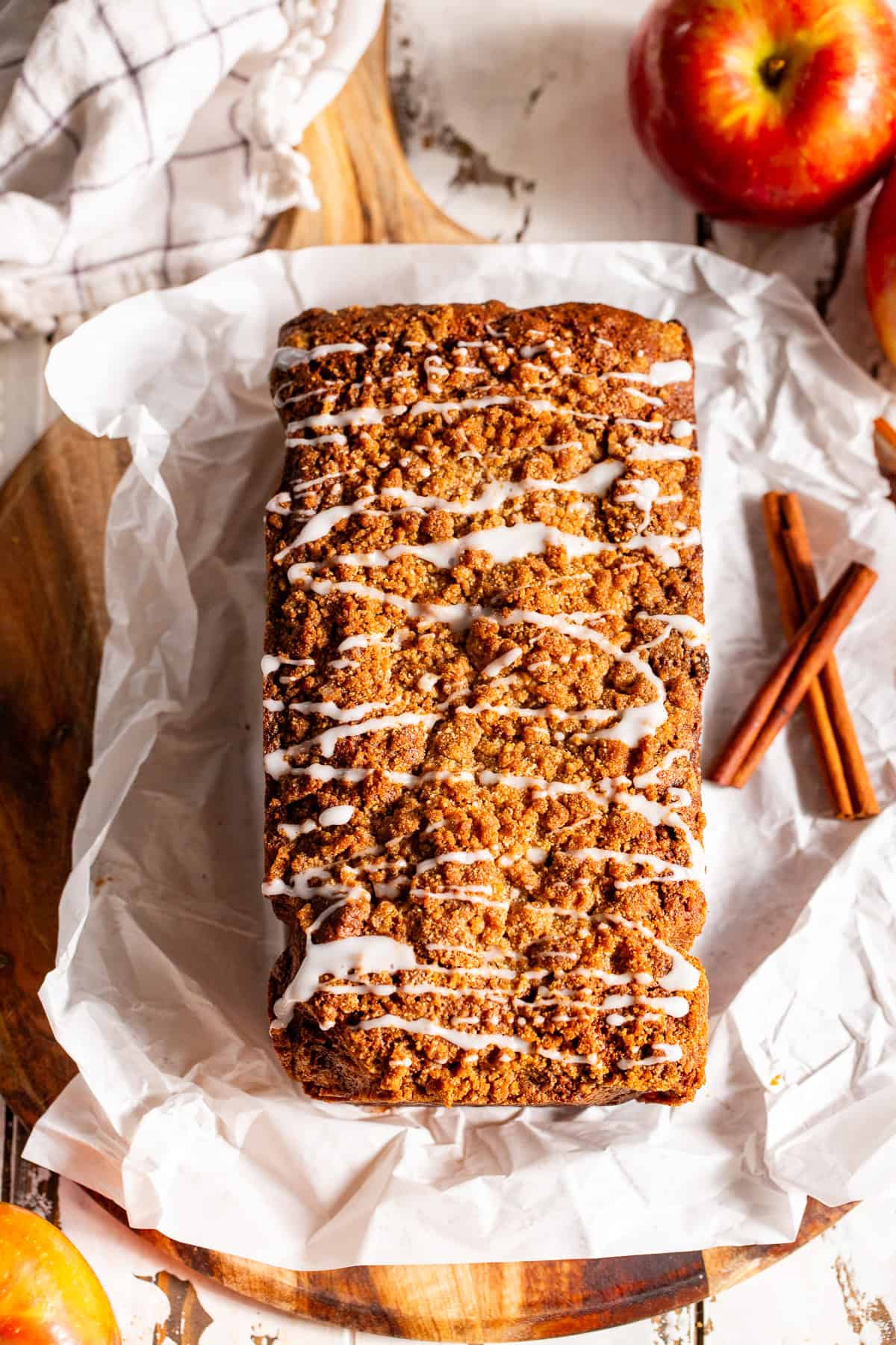 Overhead view of apple cinnamon bread with crumble topping and vanilla icing