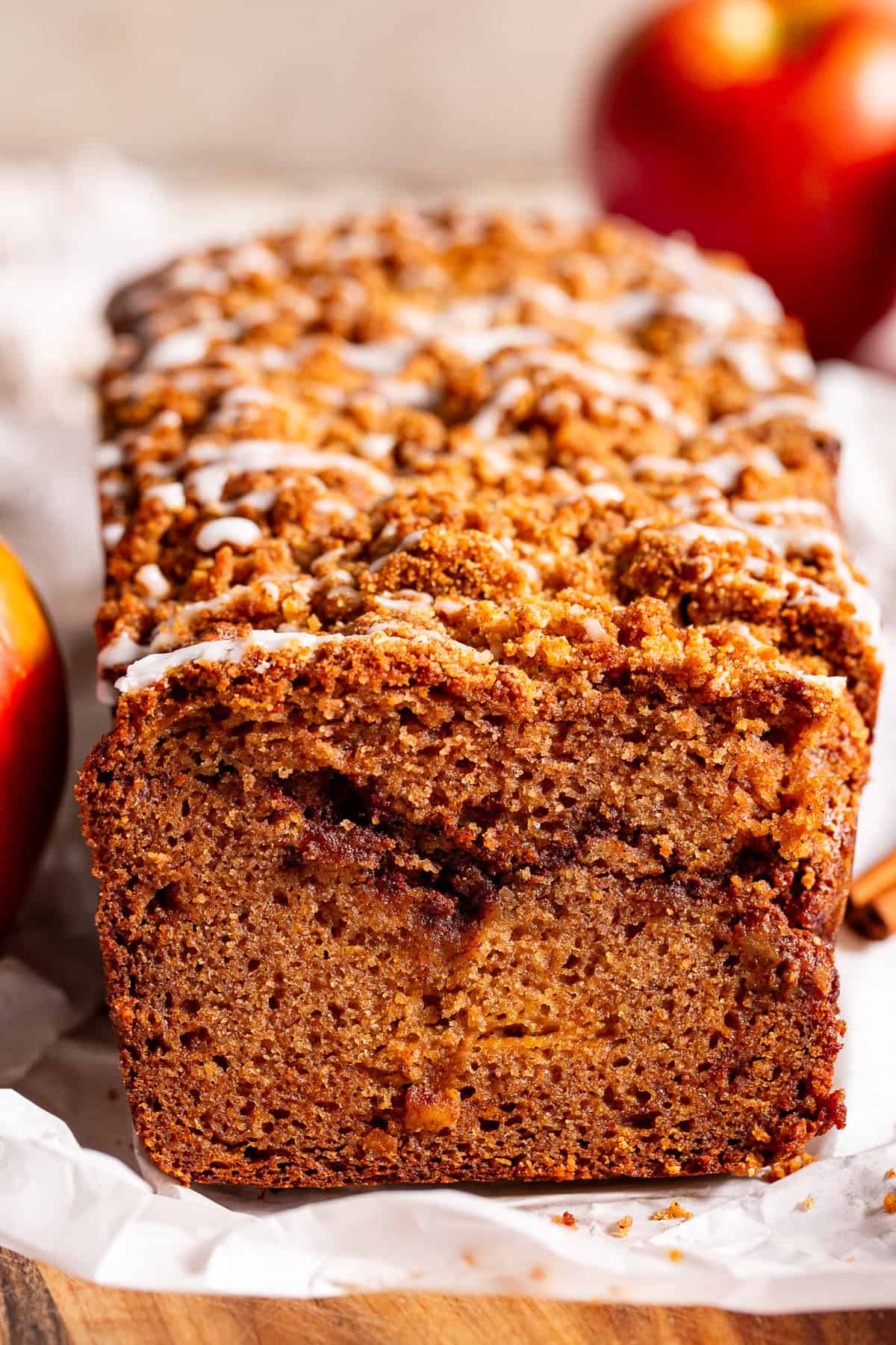 Sliced apple cinnamon bread showing apple pieces, cinnamon swirl and crumble topping