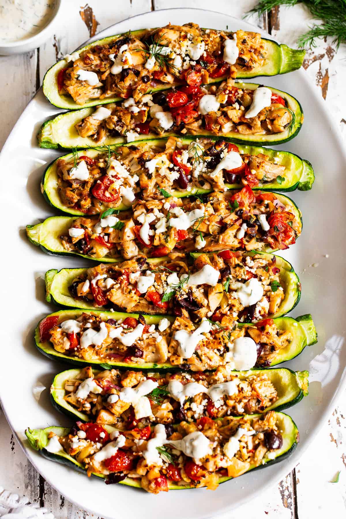 Rotisserie chicken filling with tomatoes, olives, zucchini, feta and Greek seasonings with creamy lemon dill sauce