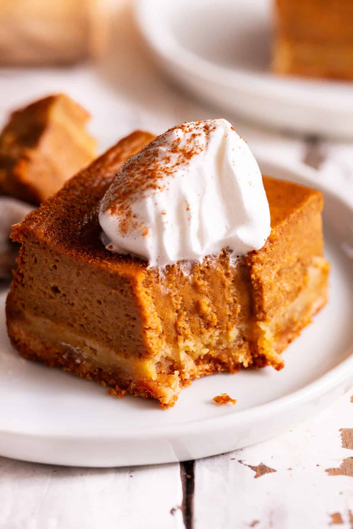Paleo pumpkin pie bar with an almond flour crust and coconut whipped cream