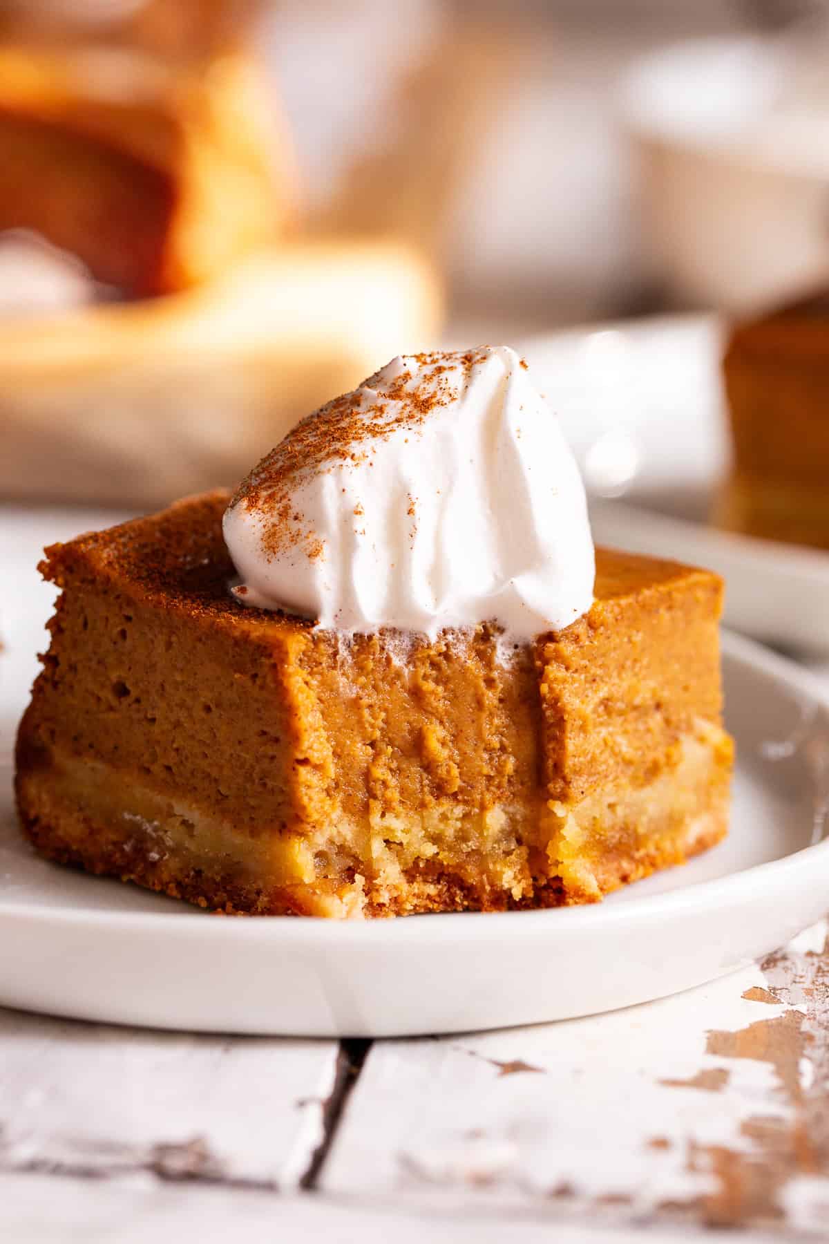 Paleo pumpkin pie bar with an almond flour crust and coconut whipped cream