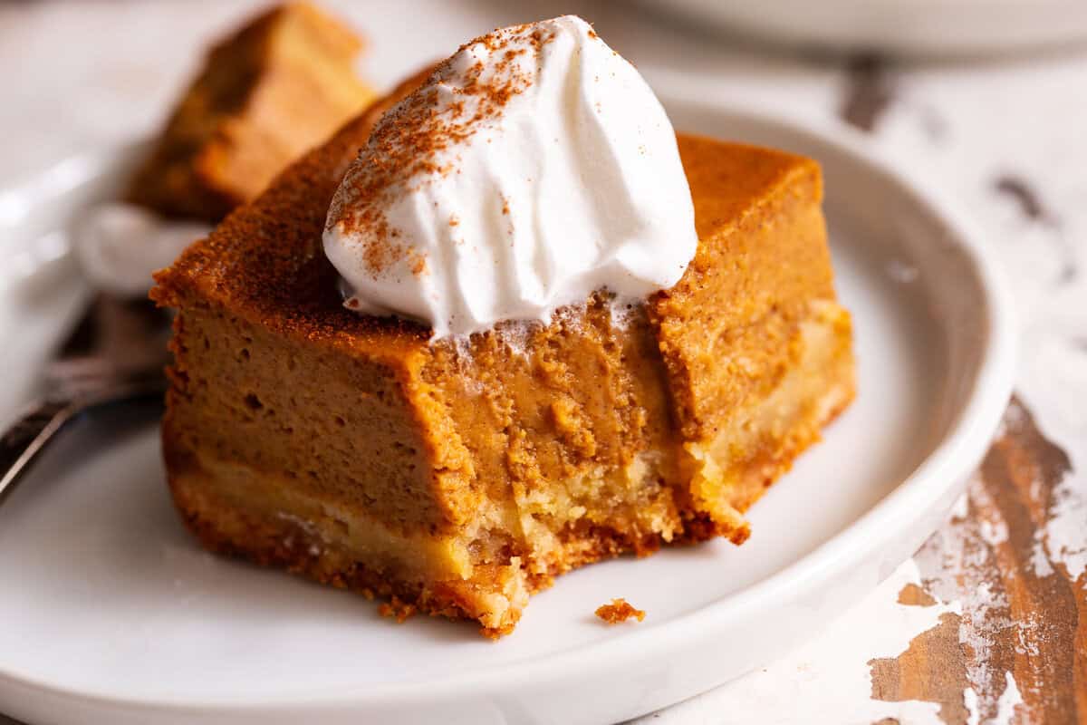 Paleo pumpkin pie bar with an almond flour crust and coconut whipped cream